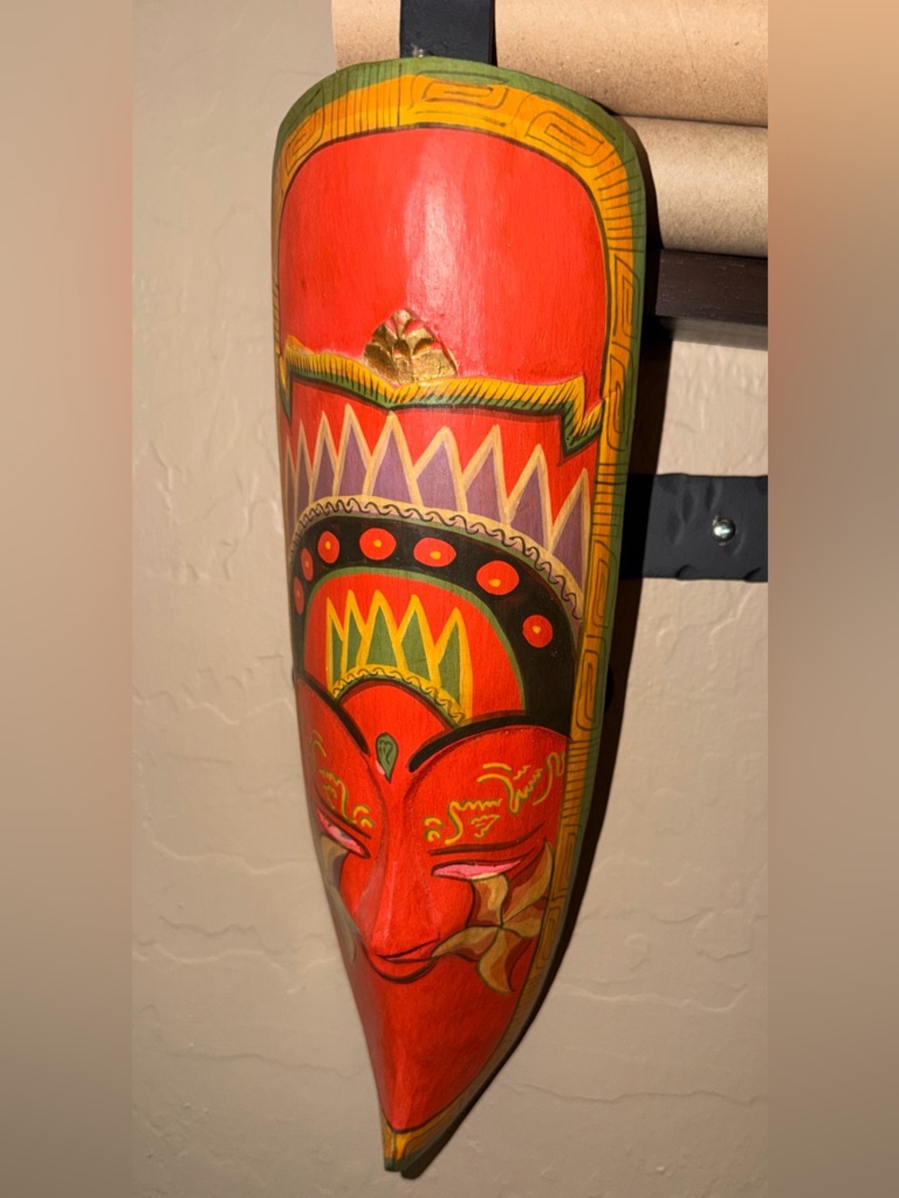 Hand-Carved Red Decorative Mask with Colorful Tribal Design